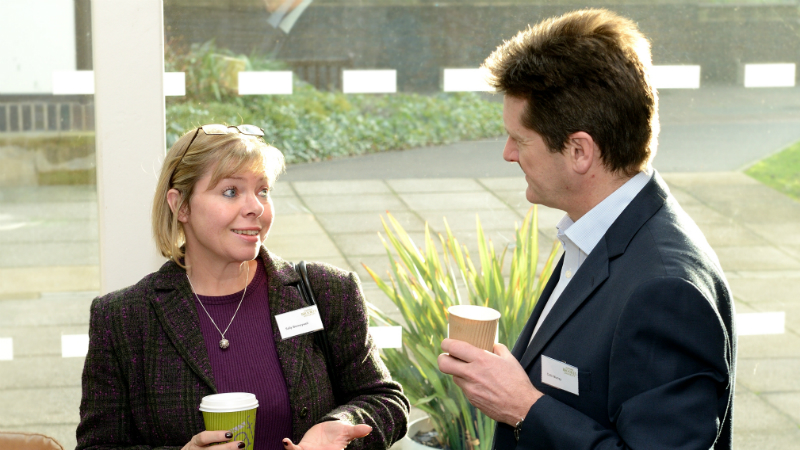Two people talking at a conference